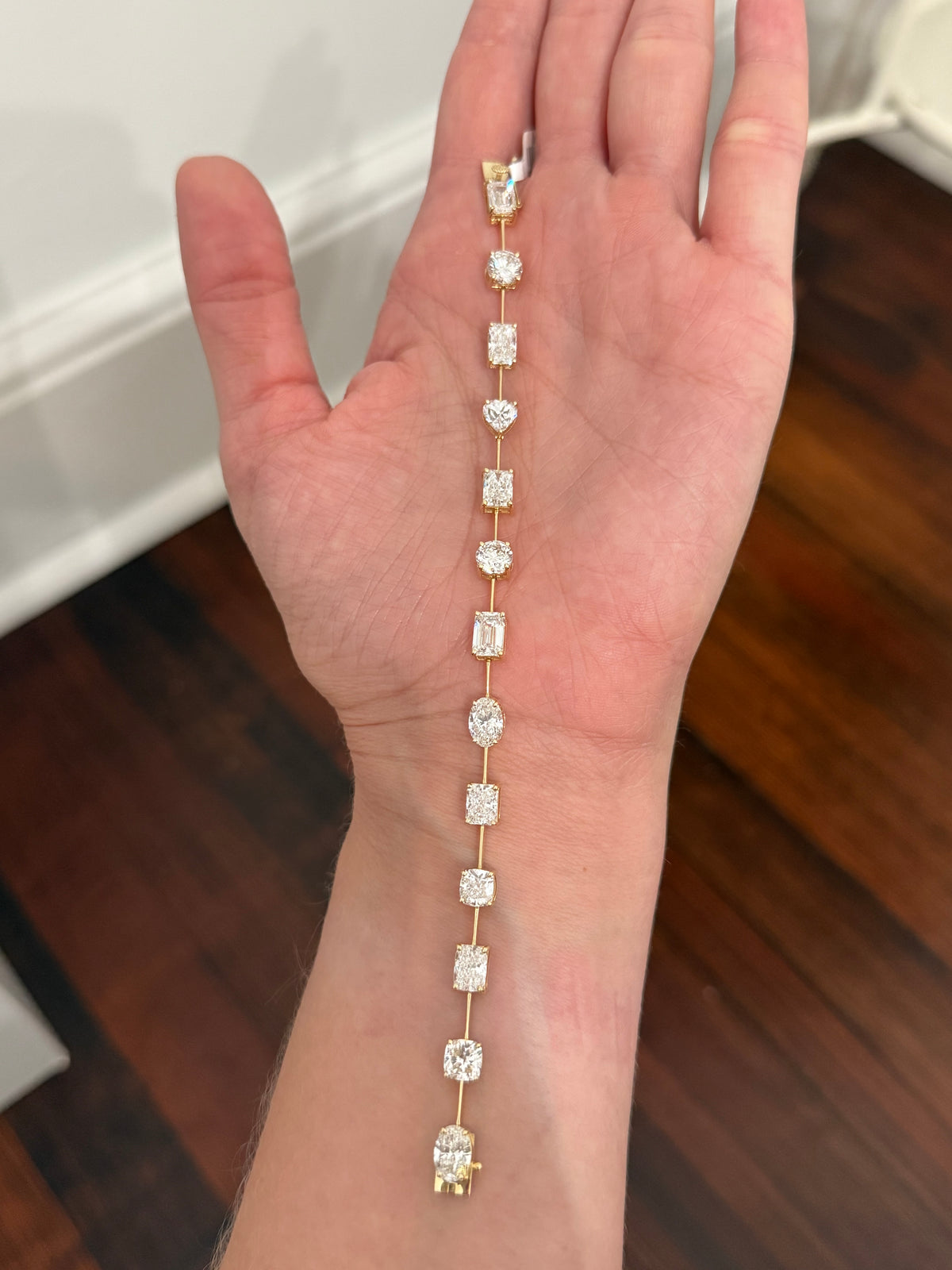 IGI certified Yellow gold mixed shape bracelet with 13.87cts of oval, round, radiant, heart shape, emerald and cushion cut lab diamonds