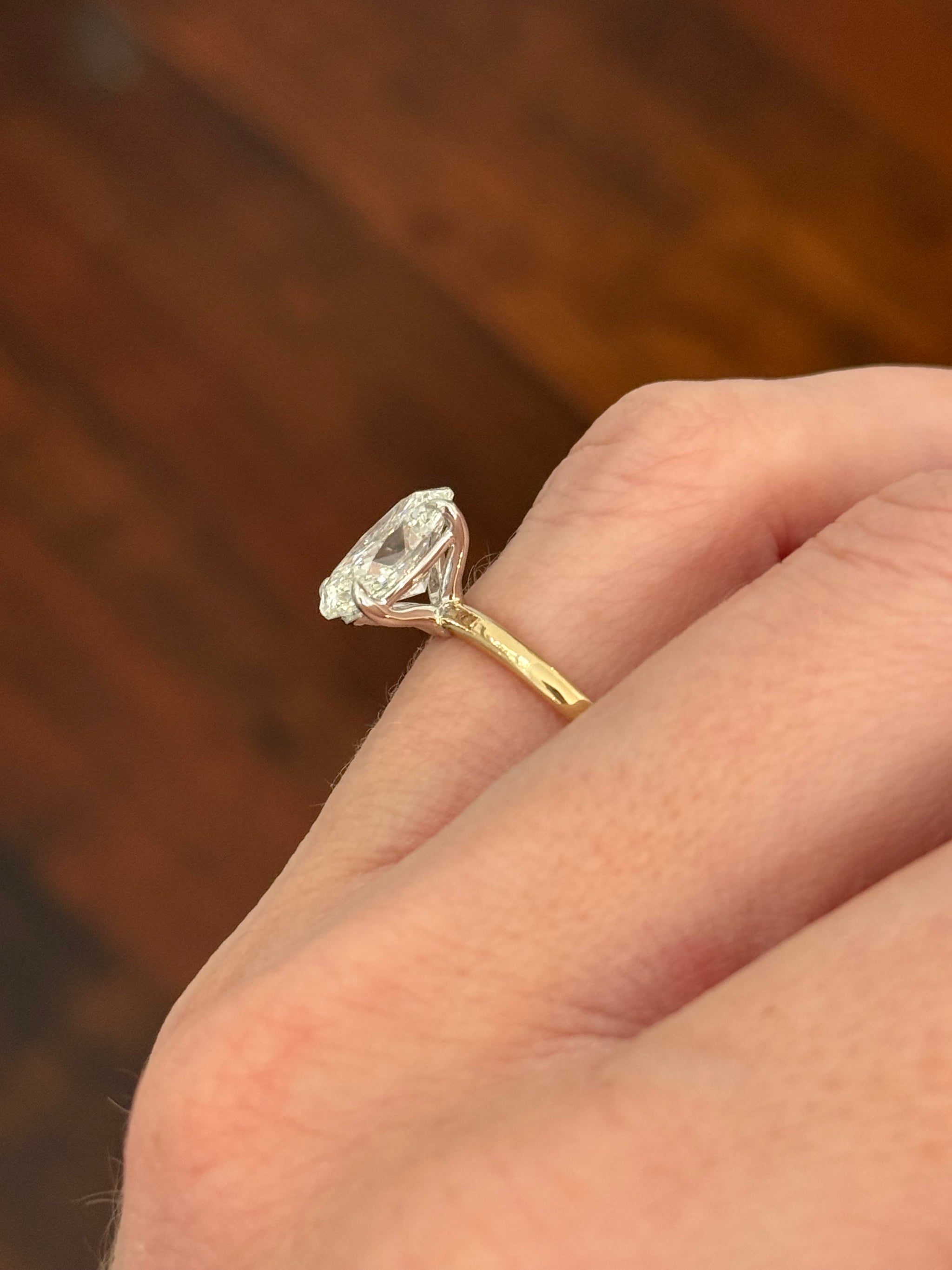 Yellow gold IGI certified oval lab diamond ring. Lab diamond is set in white gold