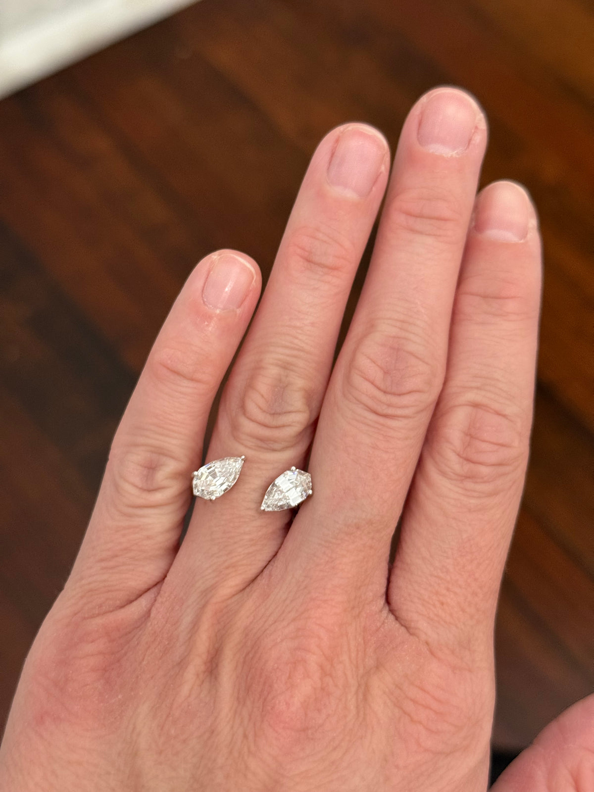 White gold 3.15ct step cut pear shape lab diamond bypass ring. Each measures 10.45x5.70mm