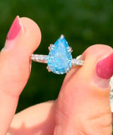 White gold pear shape blue lab diamond and white lab diamond ring