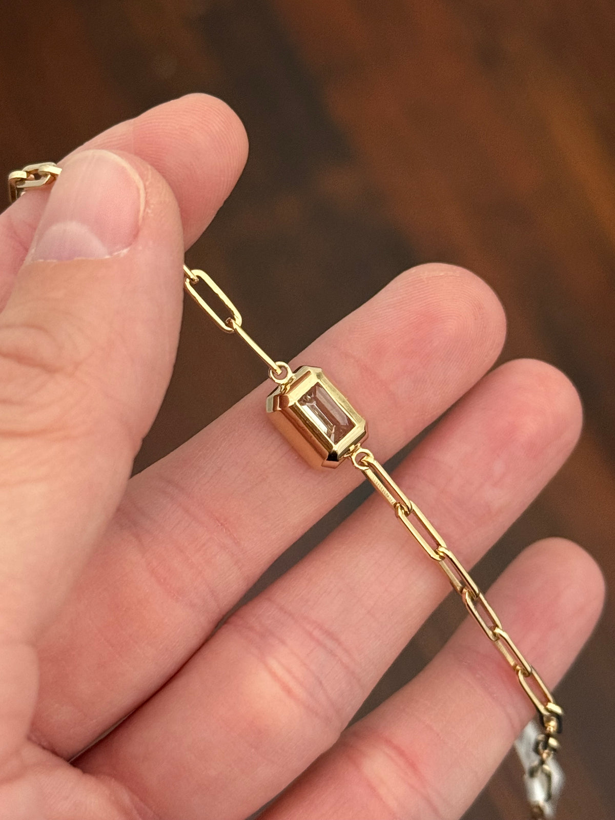 Yellow gold paperclip 3.02ct emerald cut lab diamond bracelet. Emerald cut measures 9.90x6.75mm
