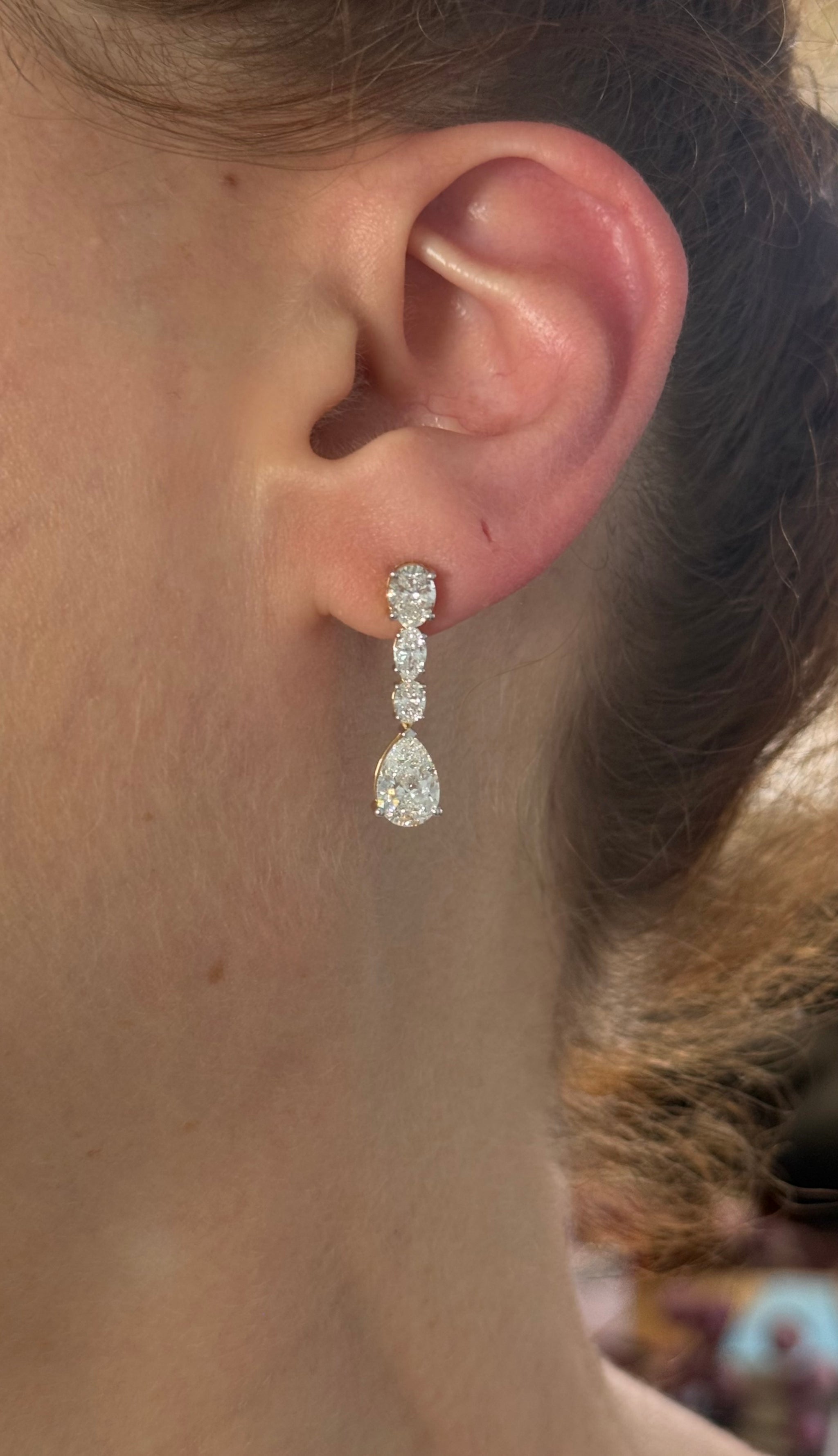 Yellow gold pear shape and oval lab diamond earrings. Prongs are white gold.