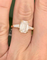 Yellow gold IGI certified emerald cut and tapered baguette lab diamond ring. Center stone is 3.03cts