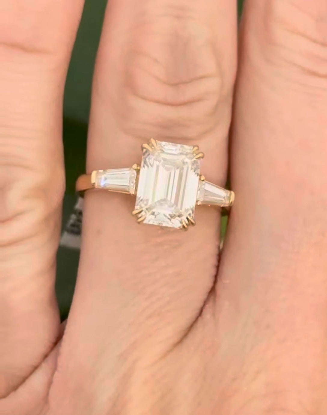 Yellow gold IGI certified emerald cut and tapered baguette lab diamond ring. Center stone is 3.03cts