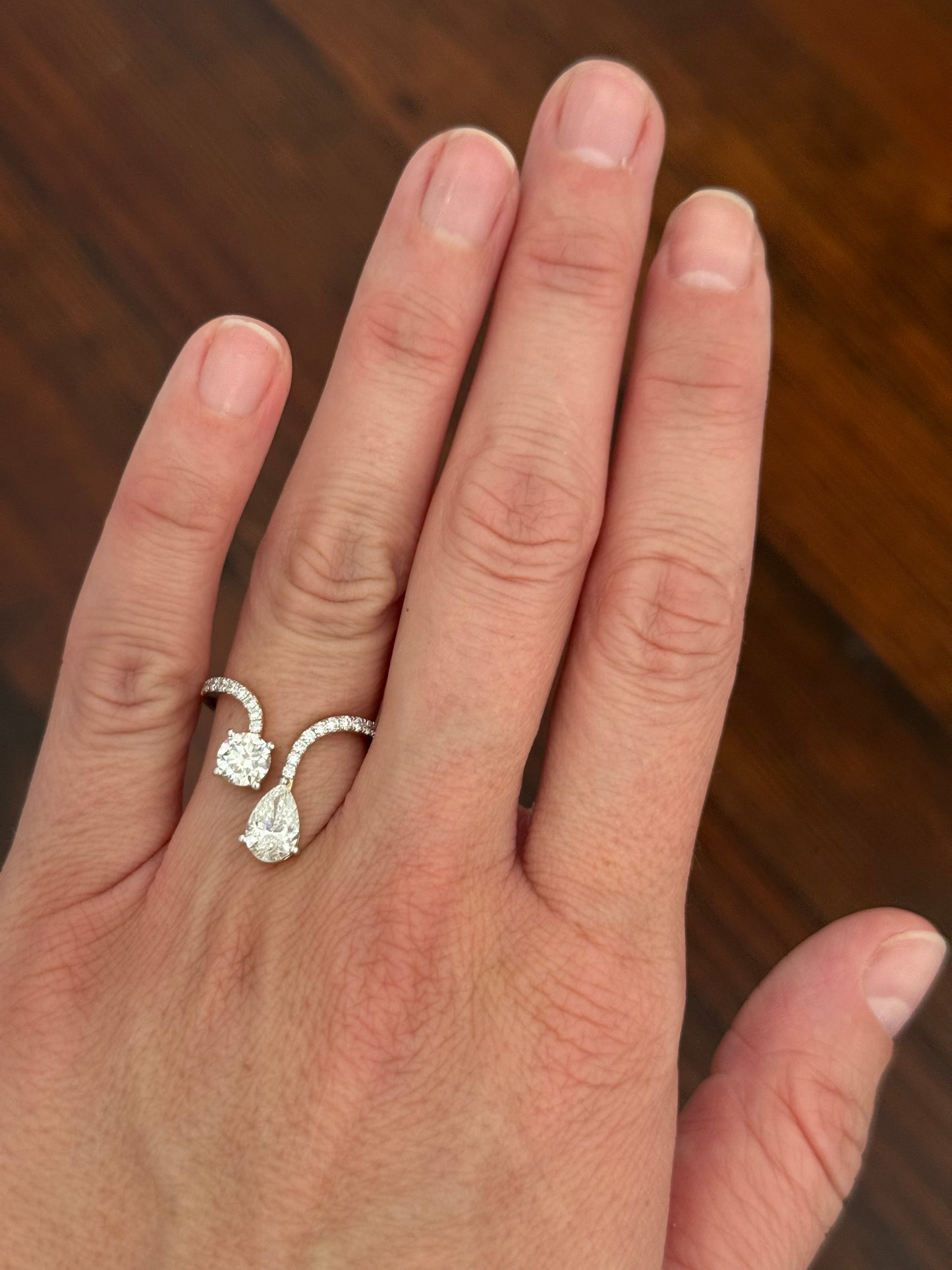 Yellow gold pear shape and round lab diamond ring. Prongs are white gold.