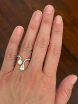 Yellow gold pear shape and round lab diamond ring. Prongs are white gold.