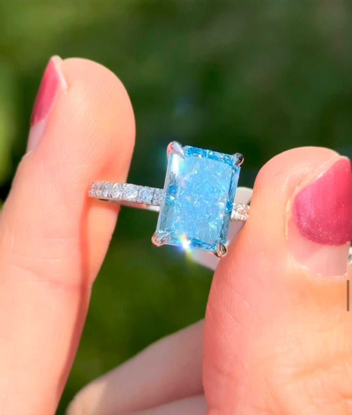 White gold radiant blue lab diamond and white lab diamond ring