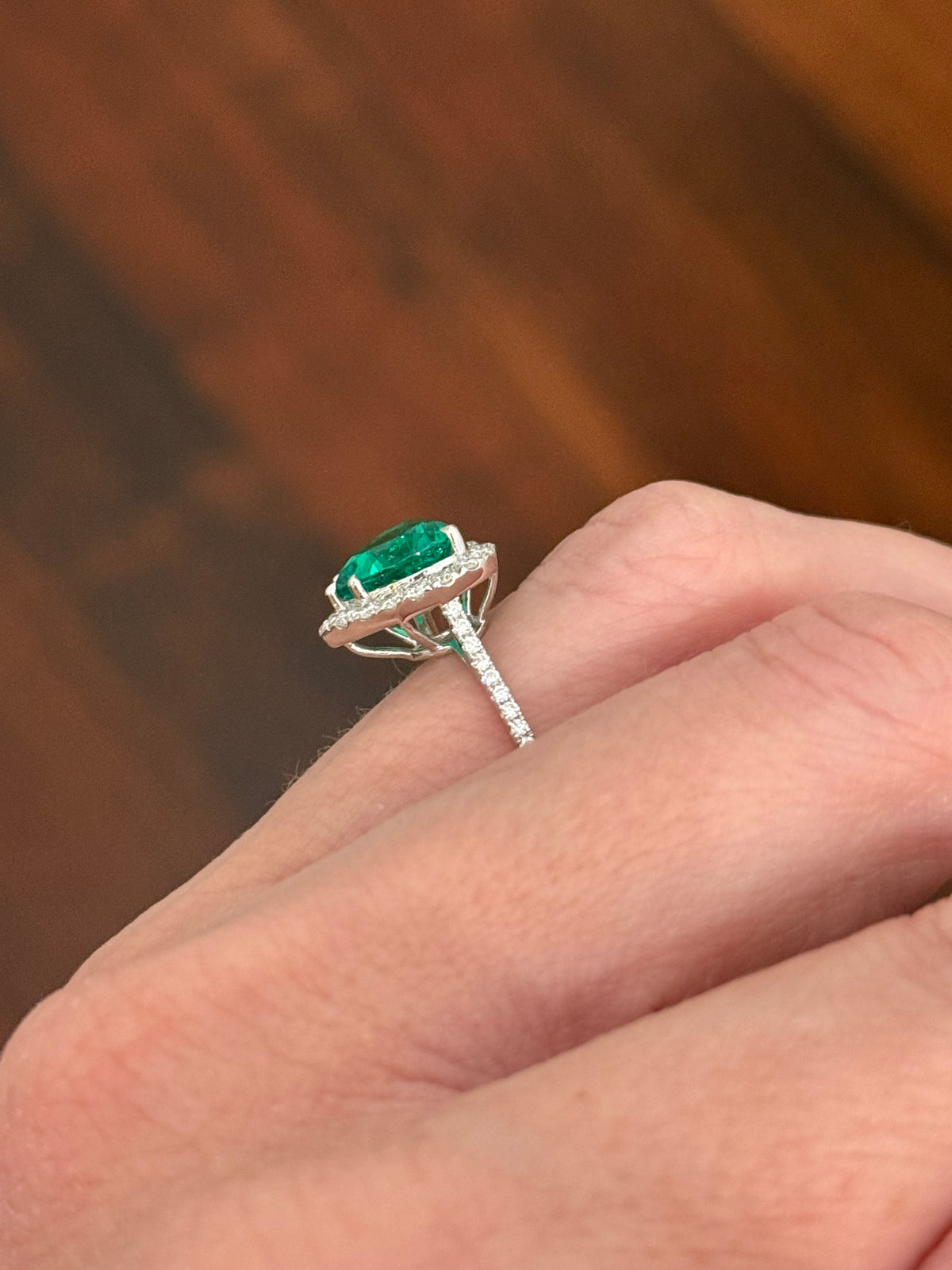 White gold heart shaped lab emerald and round lab diamond ring. Center stone is 2.32cts