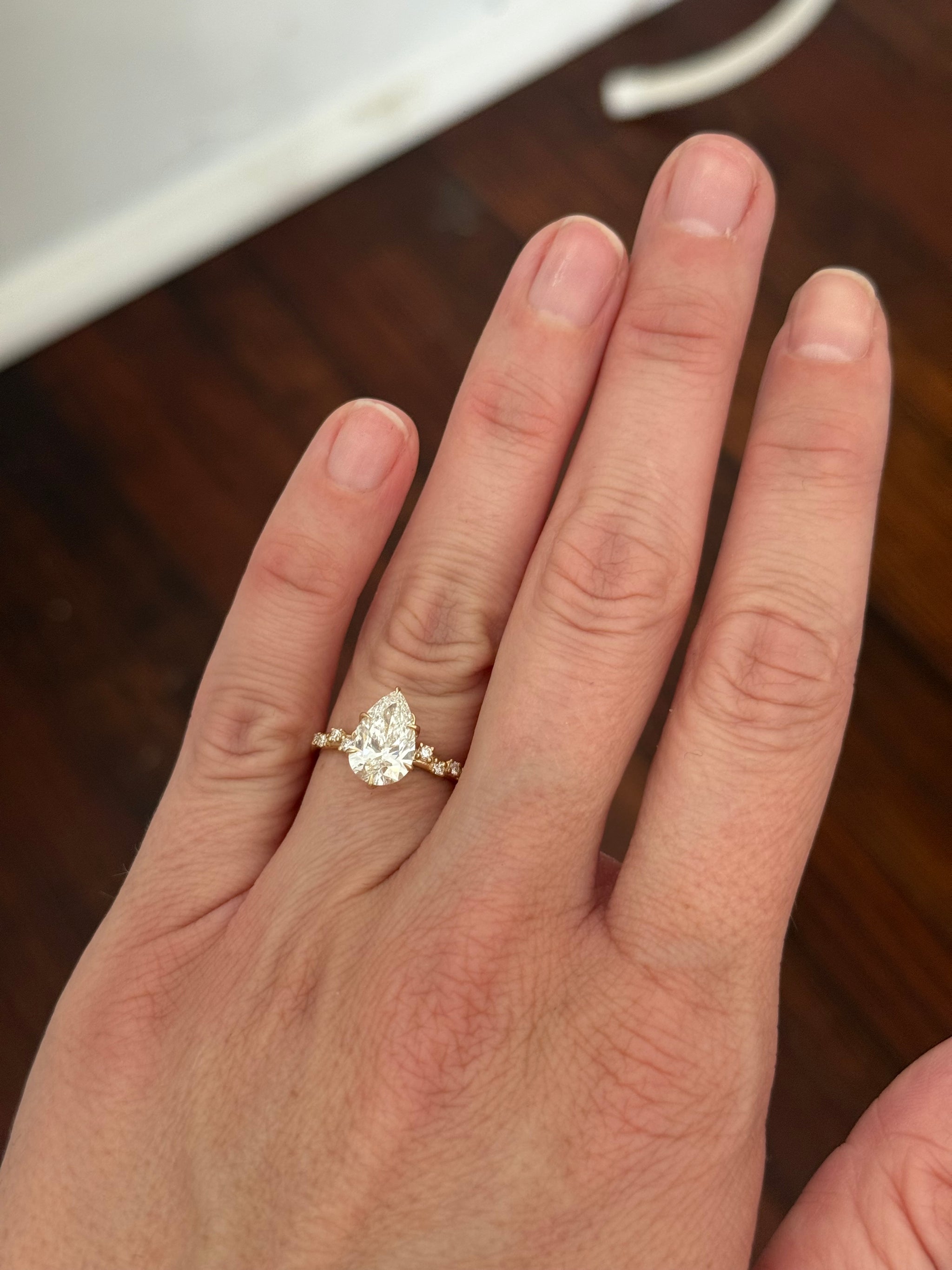 Yellow gold pear shape and round lab diamond ring