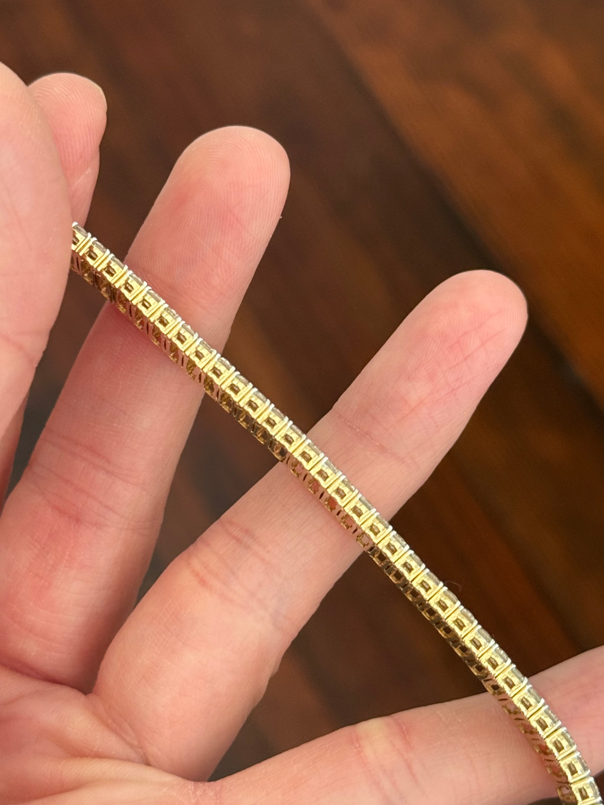 Yellow gold 17.44ct radiant yellow lab diamond and round white lab diamond bracelet. White diamond’s prongs are white gold.