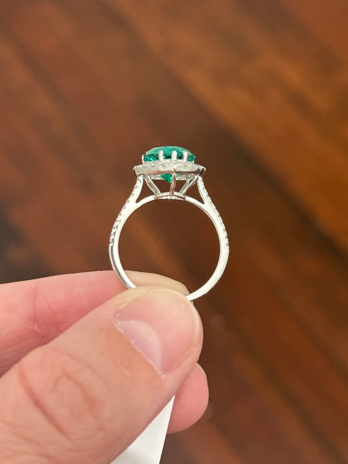 White gold heart shaped lab emerald and round lab diamond ring. Center stone is 2.32cts