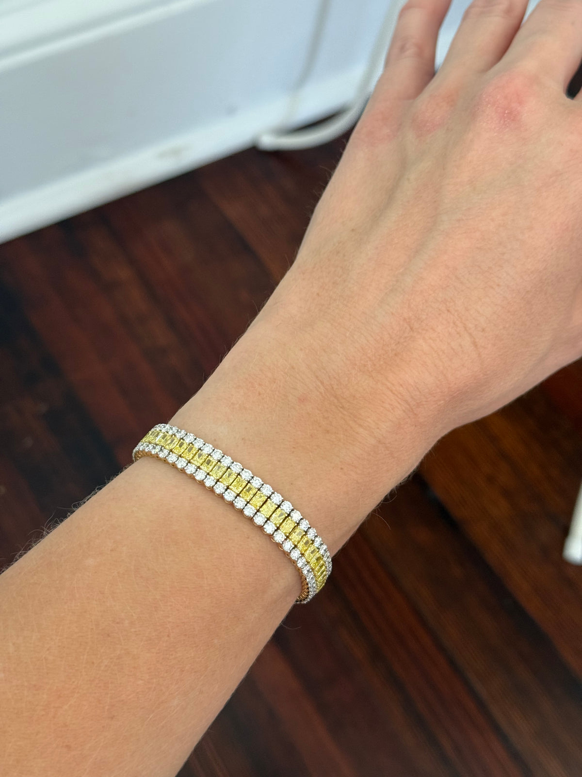 Yellow gold 17.44ct radiant yellow lab diamond and round white lab diamond bracelet. White diamond’s prongs are white gold.