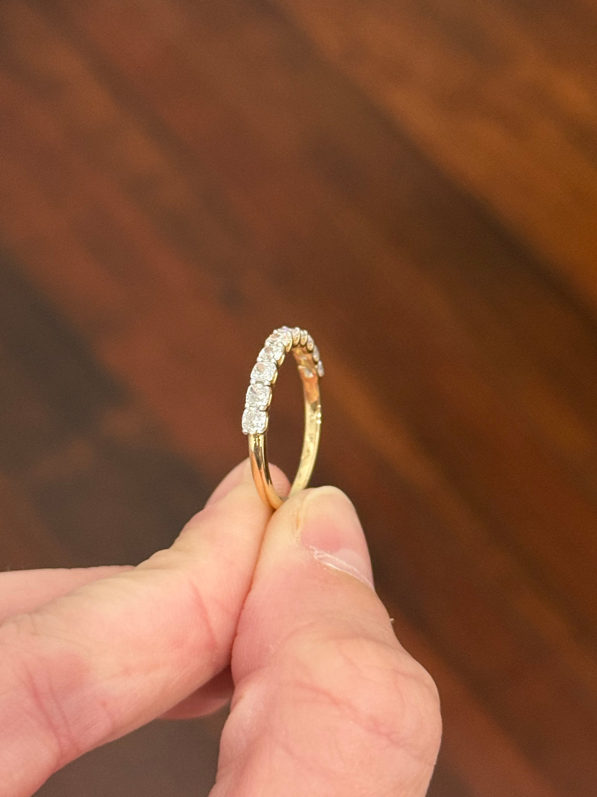 Yellow gold cushion cut lab diamond band. Prongs are white gold.
