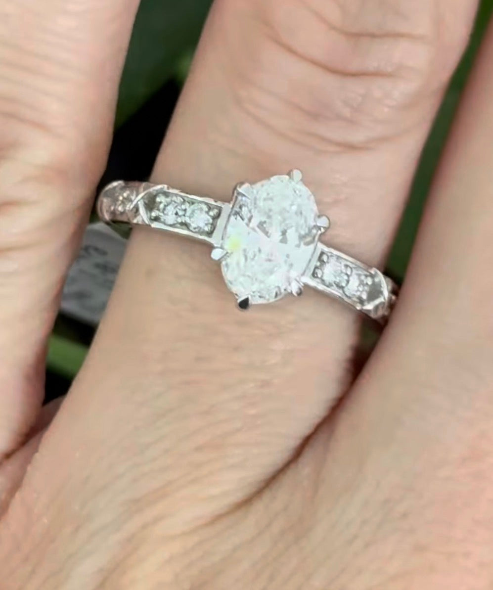 White gold oval and round lab diamond ring. Center stone is 1ct and approximately 8.5x5.5mm
