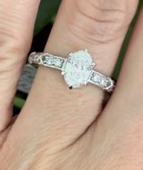 White gold oval and round lab diamond ring. Center stone is 1ct and approximately 8.5x5.5mm