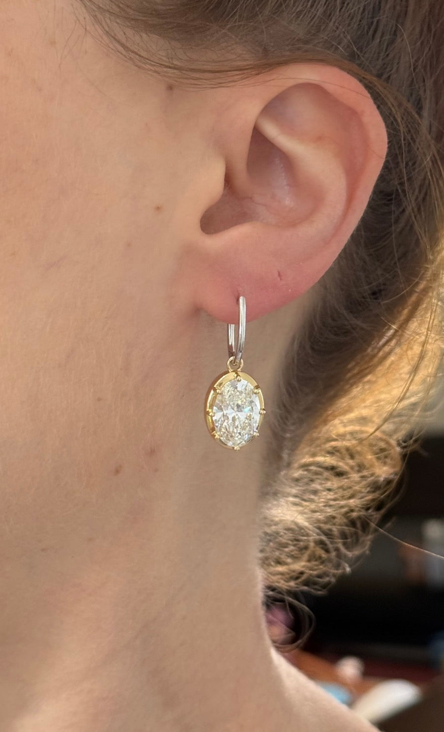 Oval lab diamond latch back earrings. Lab diamonds are set in yellow gold and earrings are white gold.