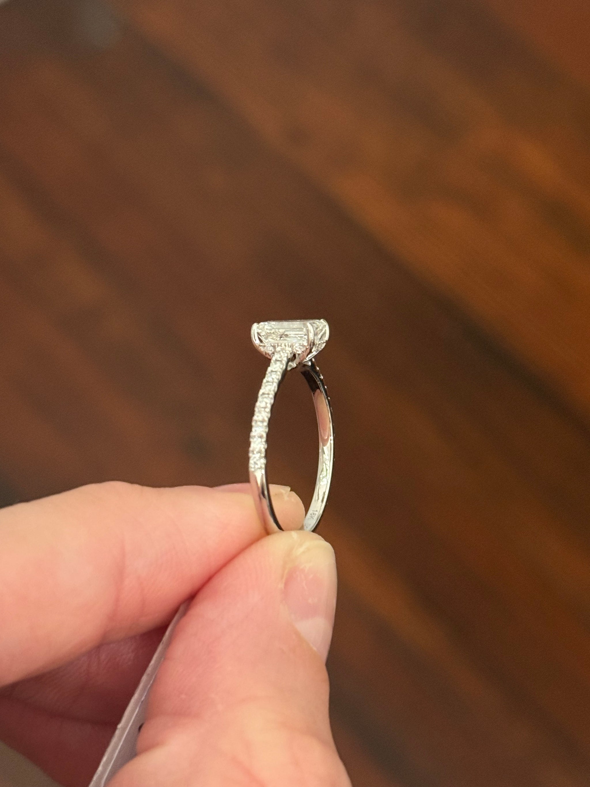 White gold 1.35ct emerald cut lab diamond ring. Center stone is 1.09cts and measures 6.7x4.3mm