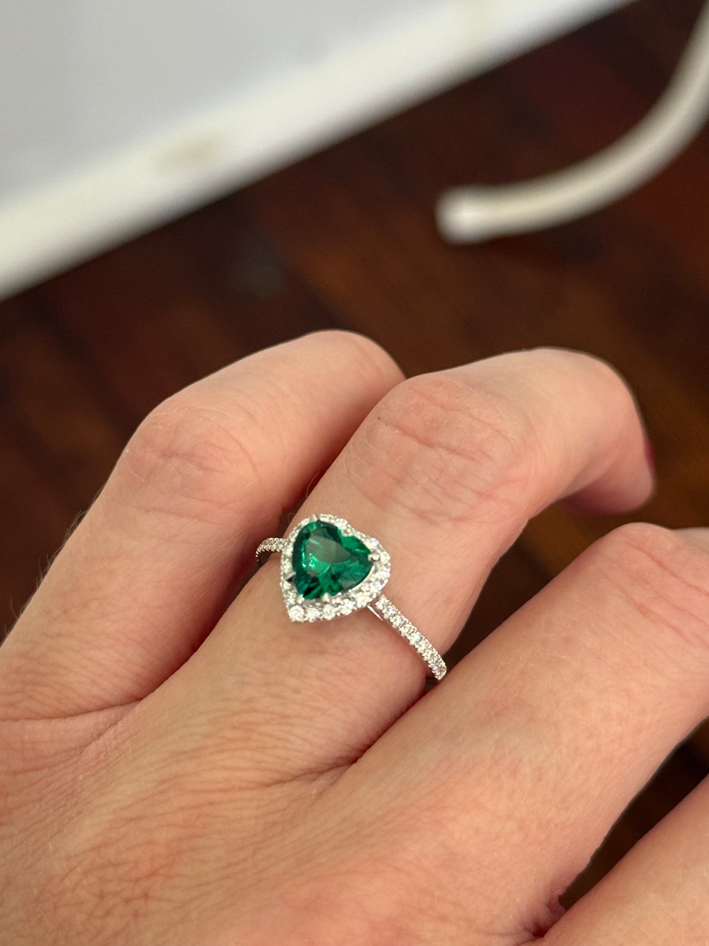 White gold heart shaped lab emerald and round lab diamond ring