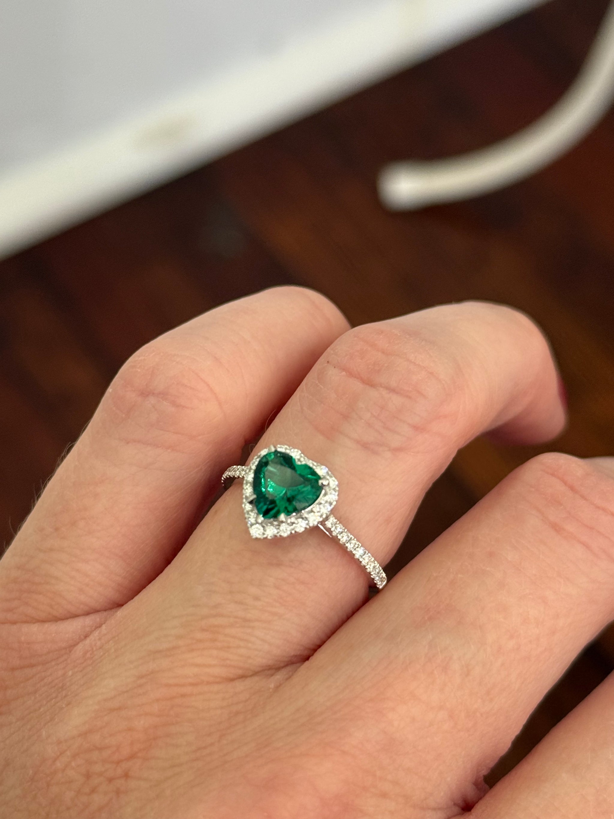 White gold heart shaped lab emerald and round lab diamond ring