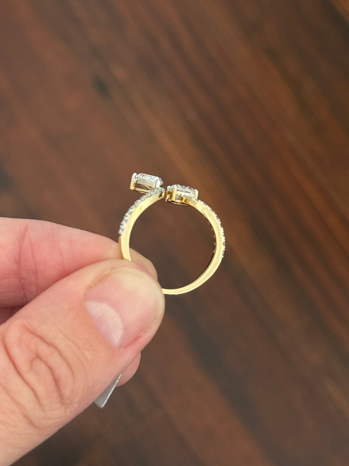 Yellow gold pear shape and round lab diamond ring. Prongs are white gold.