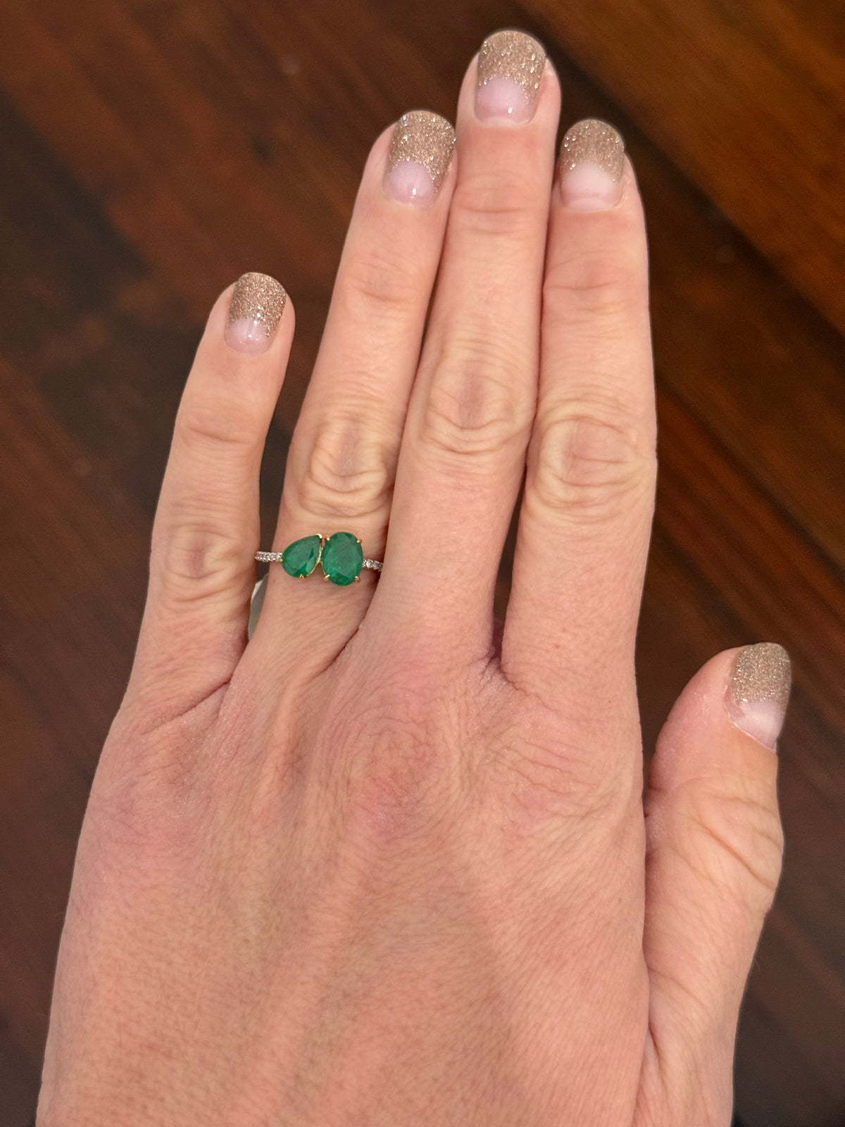 White gold natural emerald and diamond ring. Emeralds prongs are yellow gold.