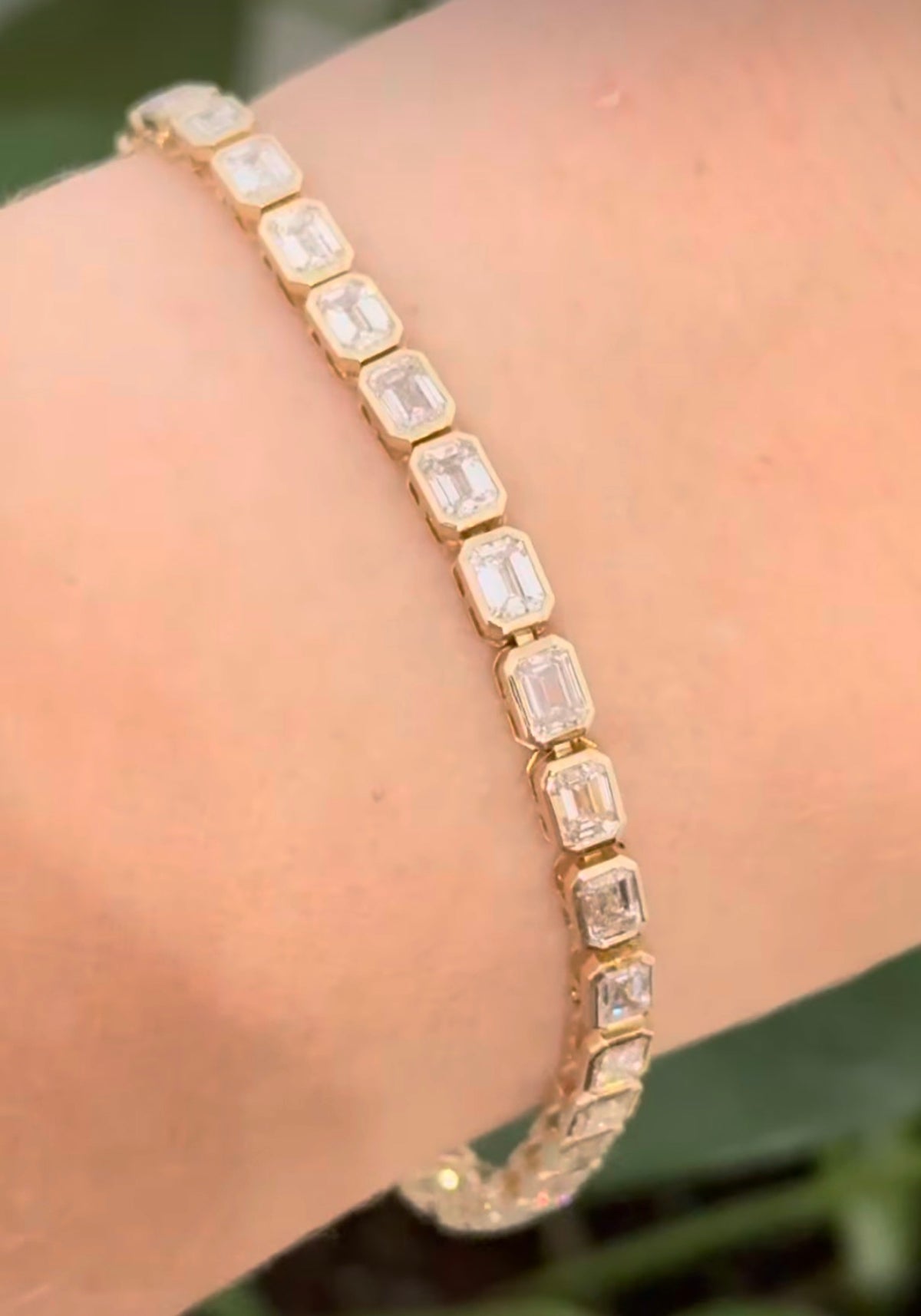 Yellow gold east west and bezel set 8.17ct emerald cut lab diamond bracelet