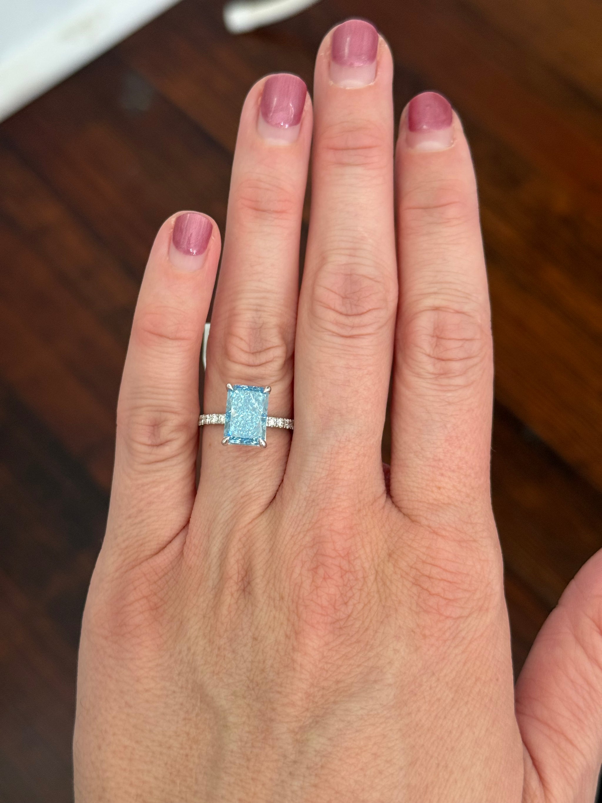 White gold radiant blue lab diamond and white lab diamond ring