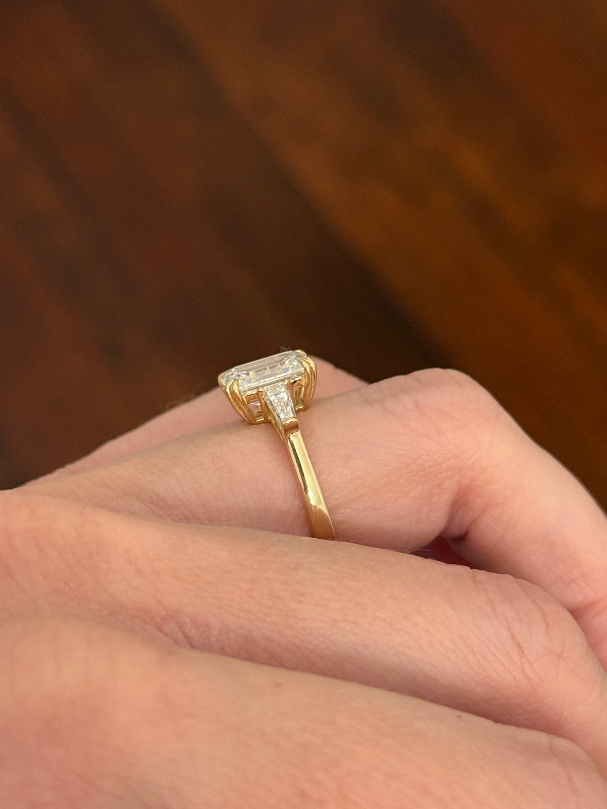 Yellow gold IGI certified emerald cut and tapered baguette lab diamond ring. Center stone is 3.03cts