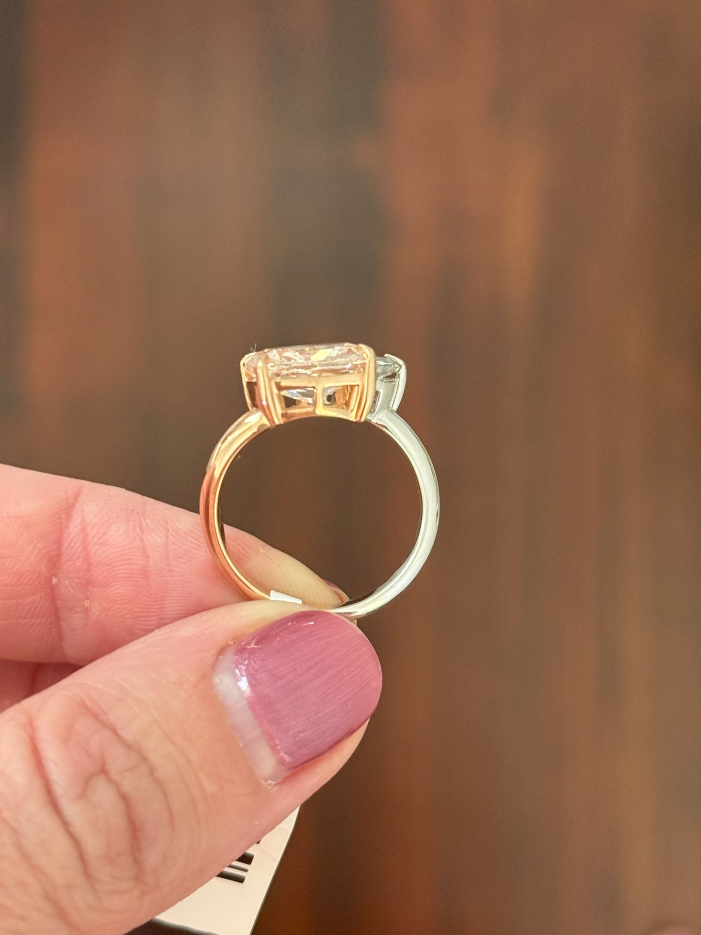 Rose and white gold cushion pink lab diamond and white marquise lab diamond toi et moi ring. Pink lab diamond is set in rose gold and white lab diamond is set in white gold.