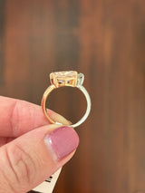 Rose and white gold cushion pink lab diamond and white marquise lab diamond toi et moi ring. Pink lab diamond is set in rose gold and white lab diamond is set in white gold.