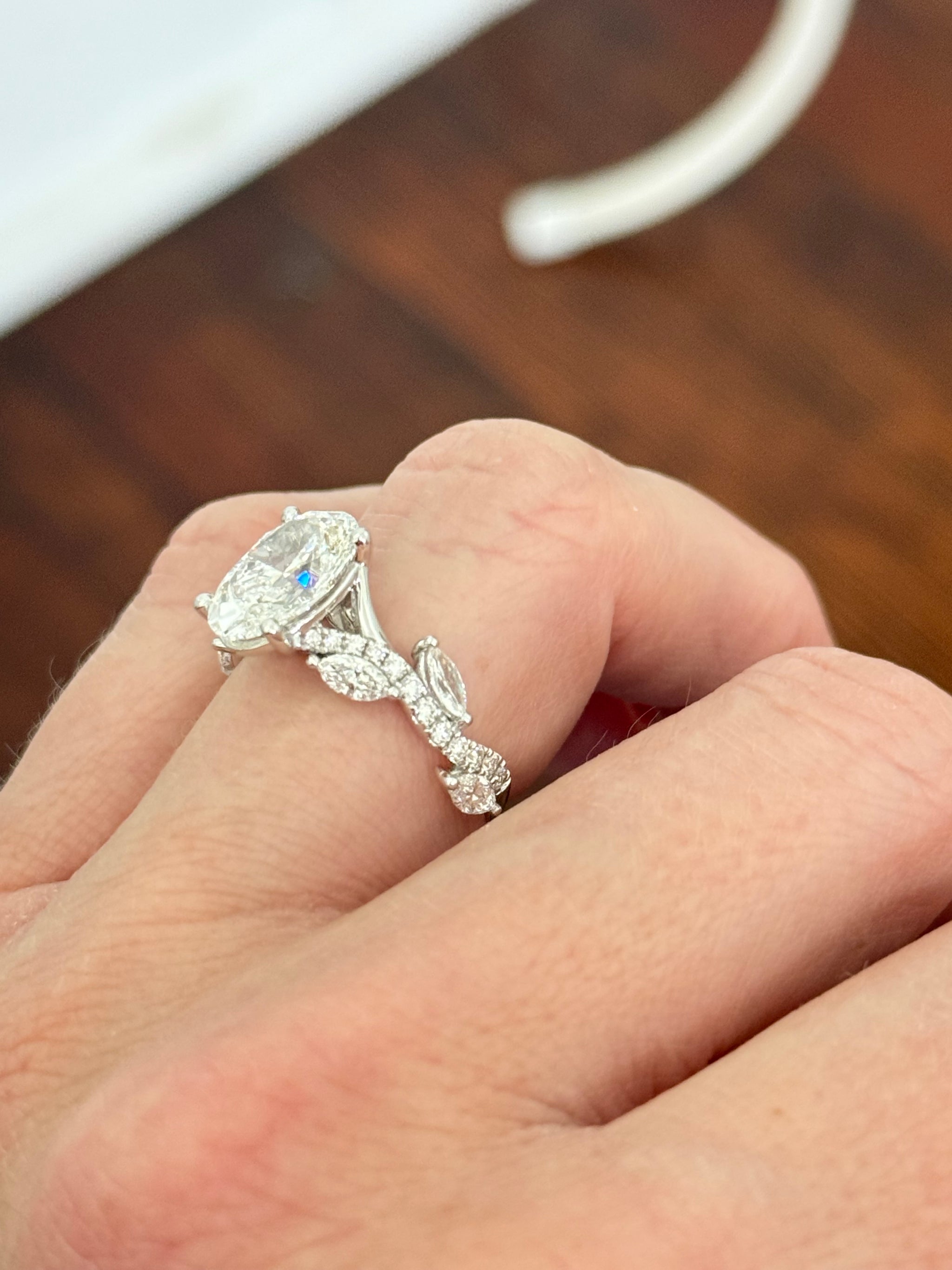 White gold oval, marquise and round lab diamond ring. Center stone is 3.07cts
