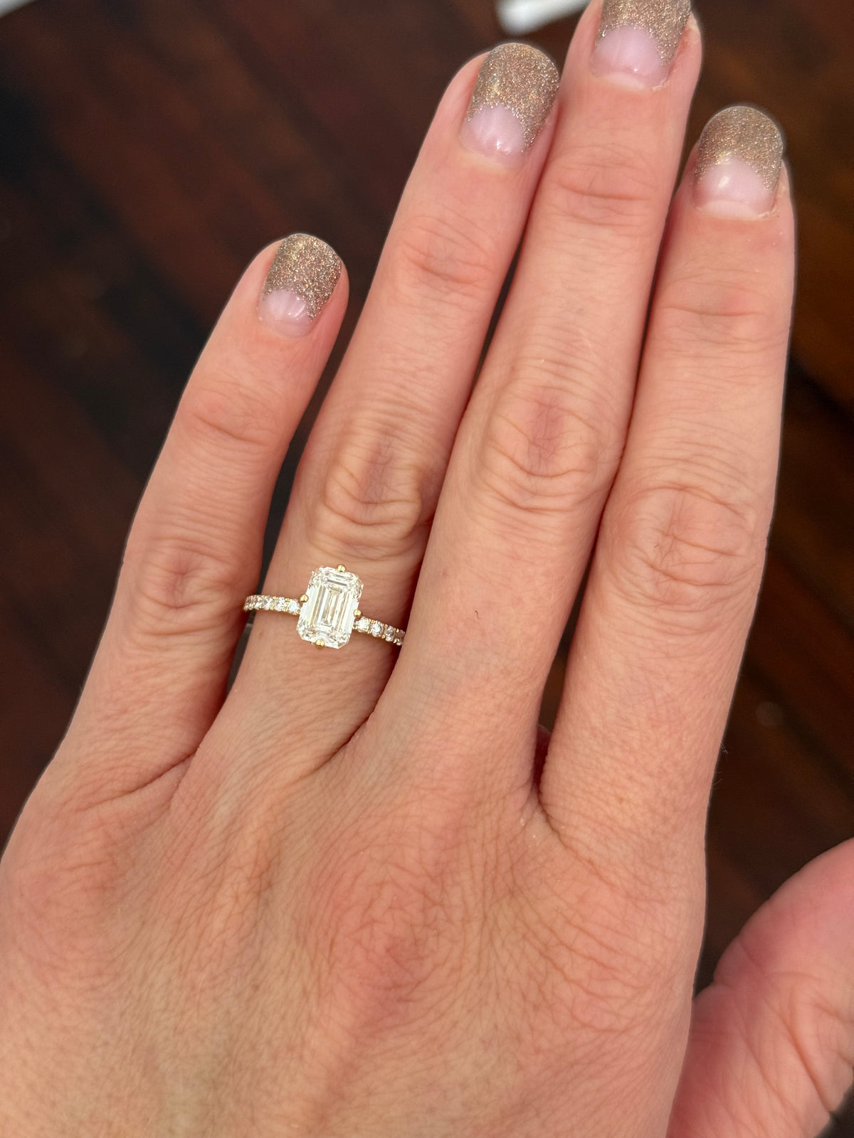 IGI certified yellow gold emerald cut and round lab diamond ring. Center stone is 1.86cts
