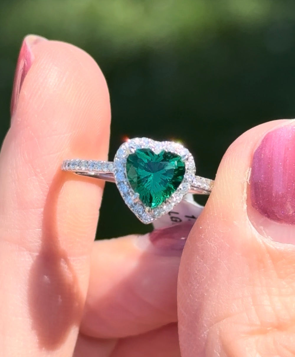 White gold heart shaped lab emerald and round lab diamond ring