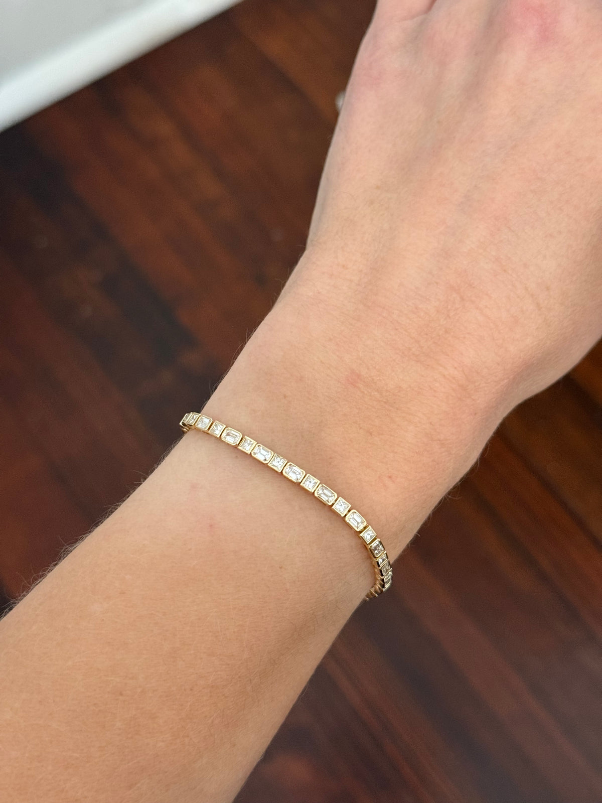 Yellow gold bezel and east west set 4.5ct emerald and princess cut natural diamond bracelet