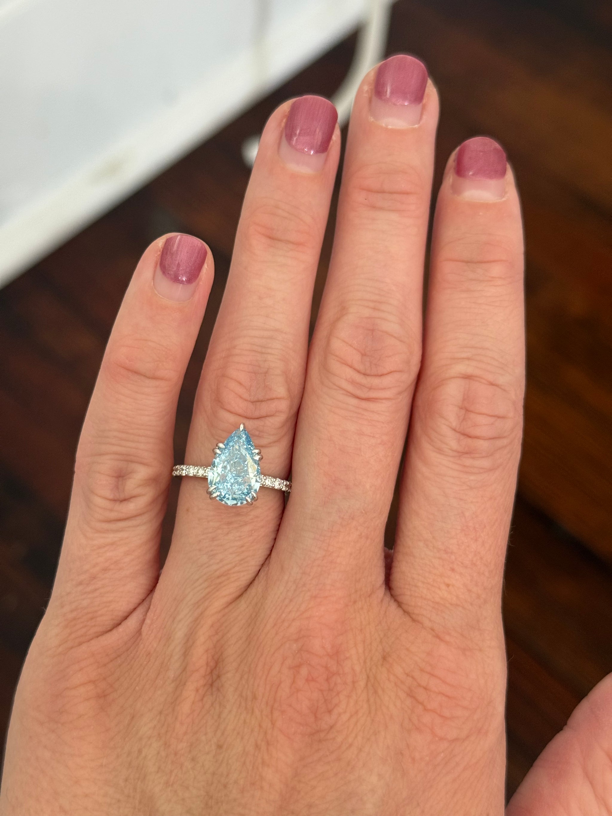 White gold pear shape blue lab diamond and white lab diamond ring