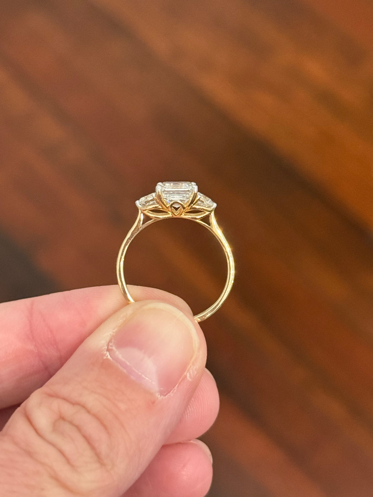 Yellow gold asscher and round lab diamond ring. Prongs are white gold.