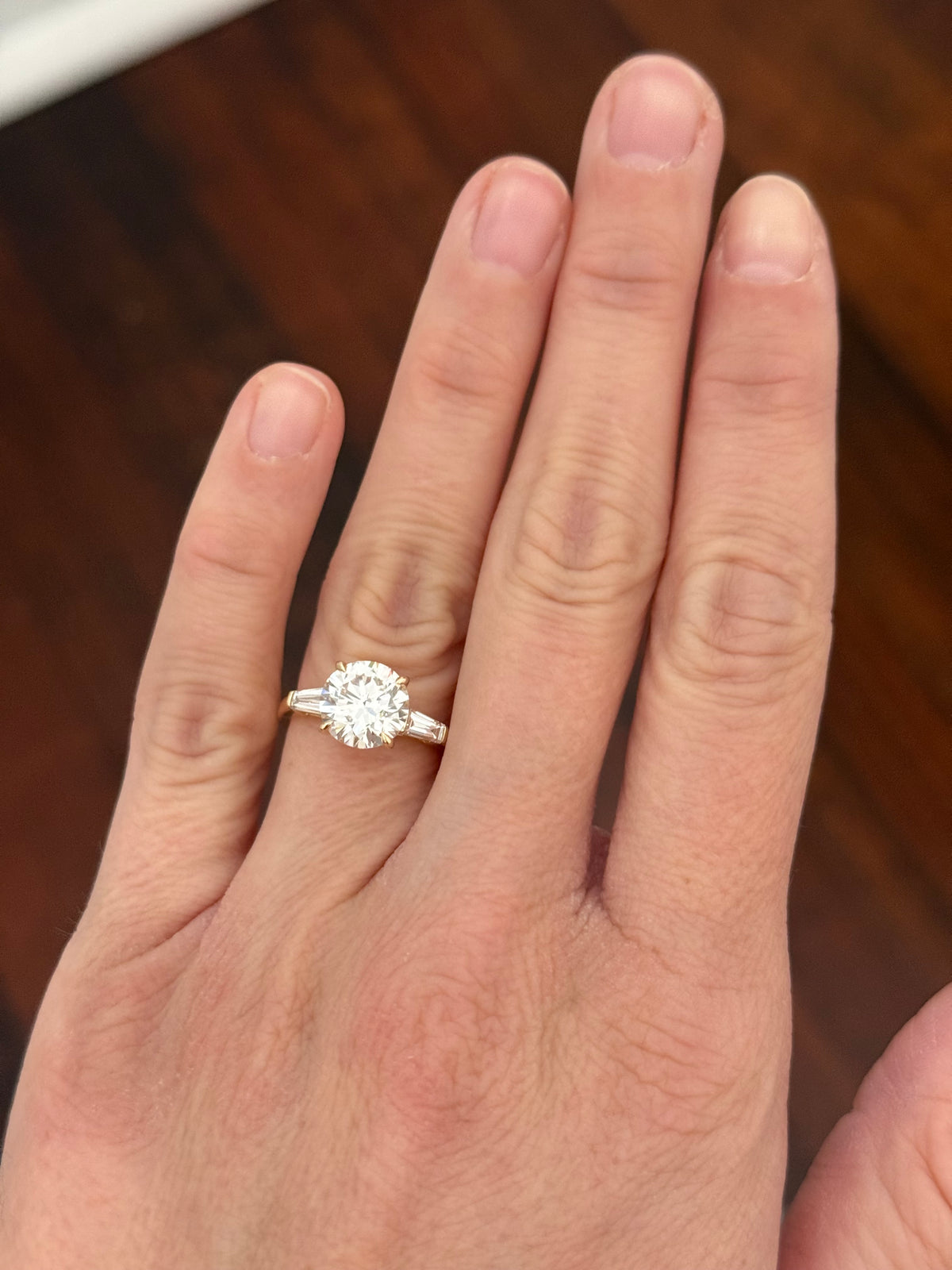 Yellow gold IGI certified 3.0ct round lab diamond and tapered baguette lab diamond ring. Round measures 9.18x5.71mm
