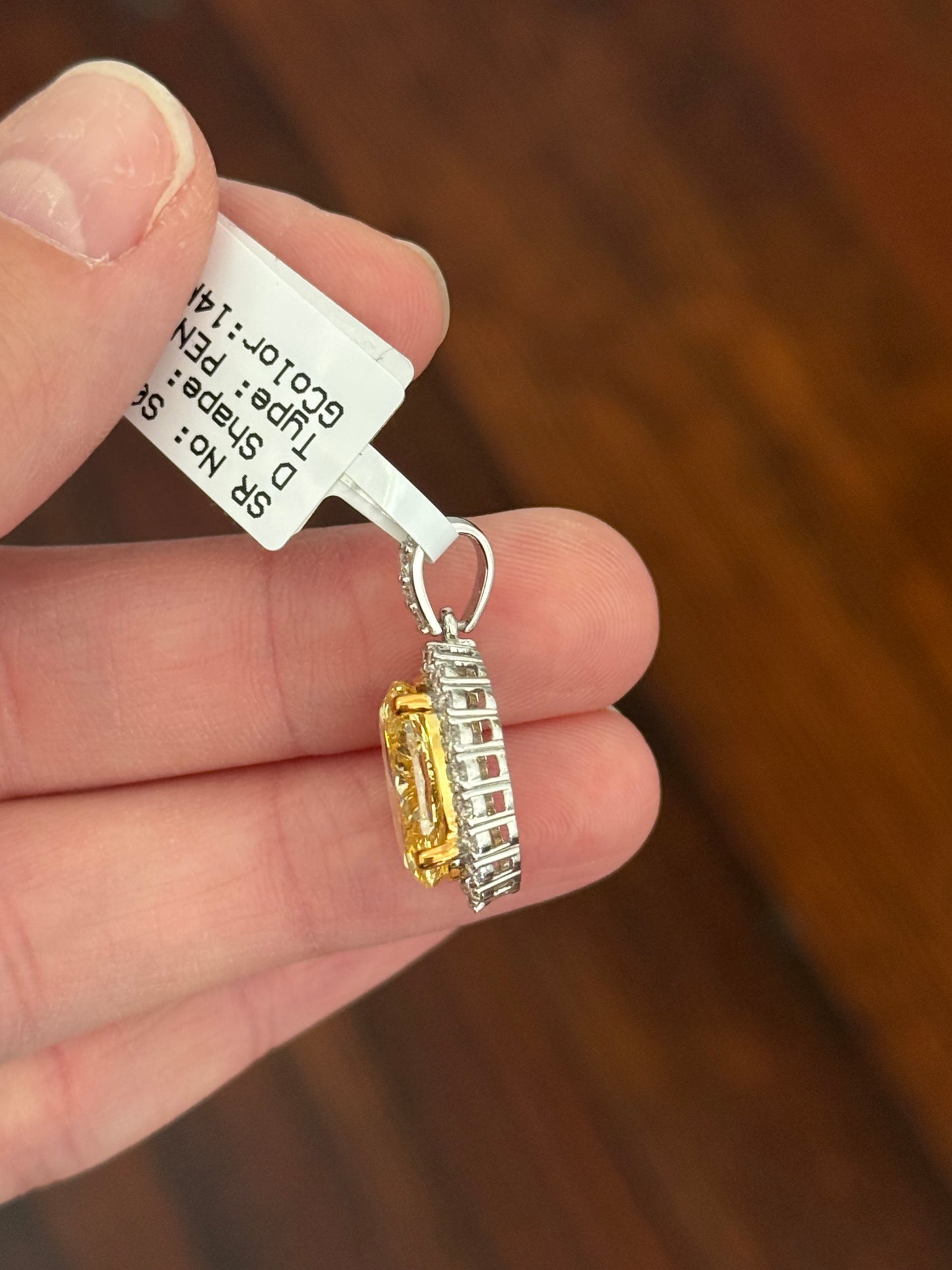 White gold oval yellow lab diamond and white round lab diamond pendant. Yellow lab diamond has yellow gold prongs and is IGI certified 5.11cts fancy vivid yellow VS2