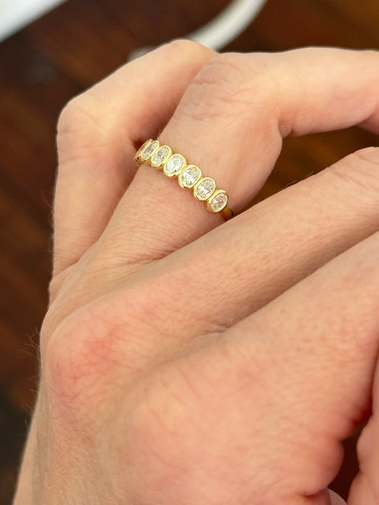 Yellow gold bezel set oval lab diamond band
