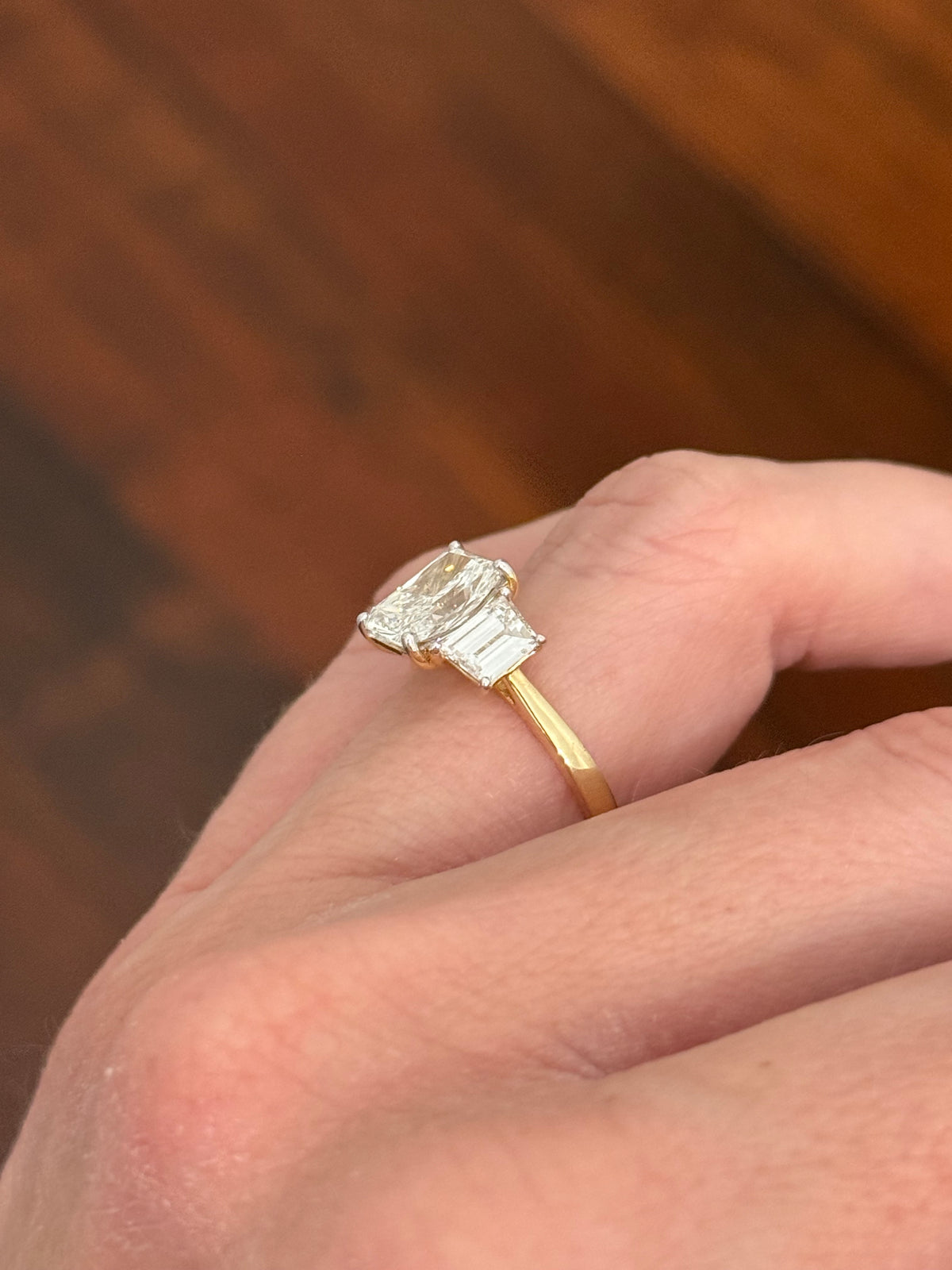 Yellow gold radiant and trapezoid lab diamond ring. Prongs are white gold.