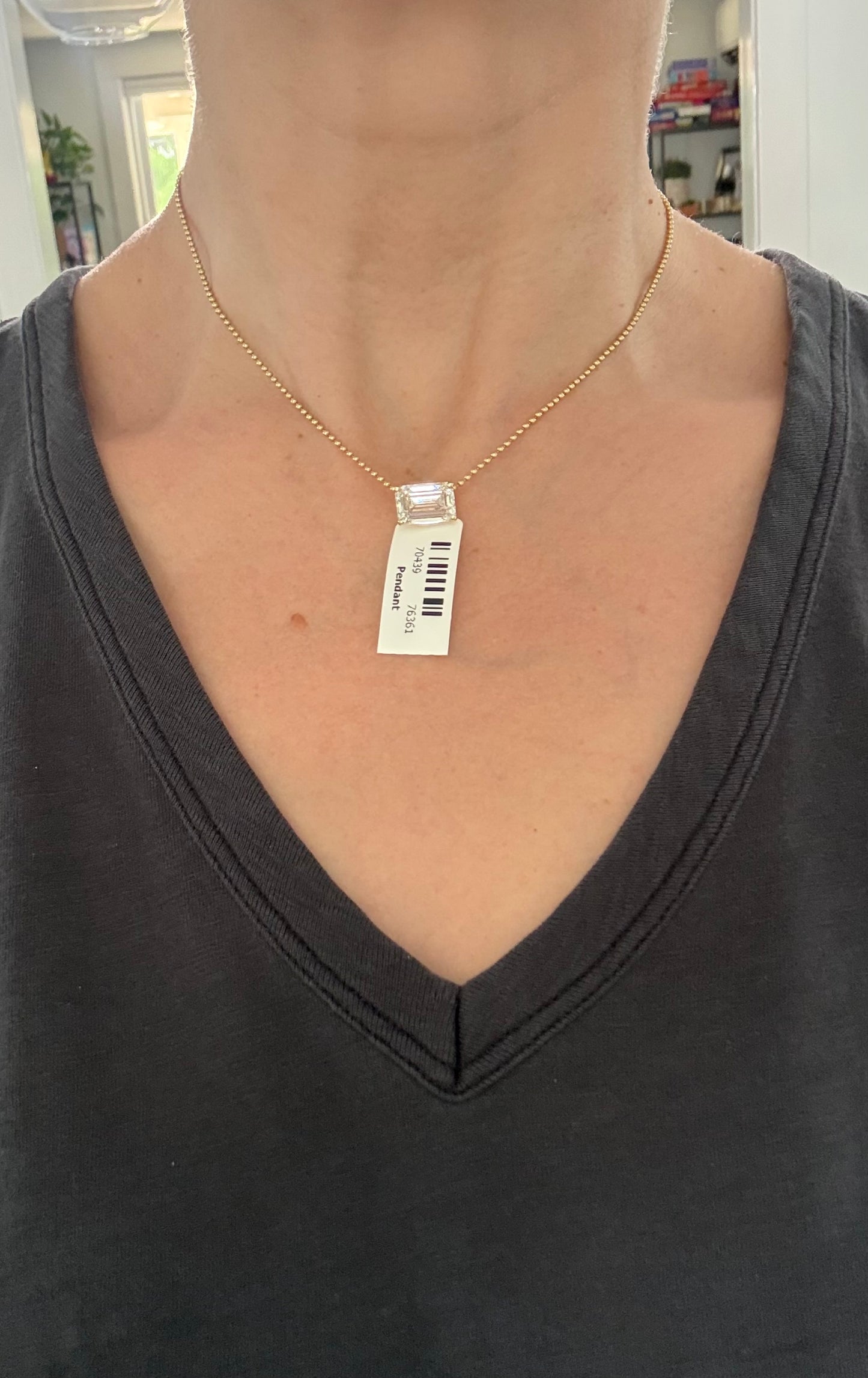 Yellow gold IGI certified 6.09ct emerald cut lab diamond pendant. Can be worn either east west or north south.