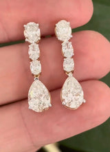 Yellow gold pear shape and oval lab diamond earrings. Prongs are white gold.