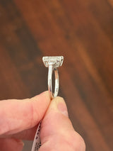 White gold IGI certified 3.04ct emerald cut lab diamond and trapezoid lab diamond ring. Emerald cut measures 10.12x6.70x4.46mm