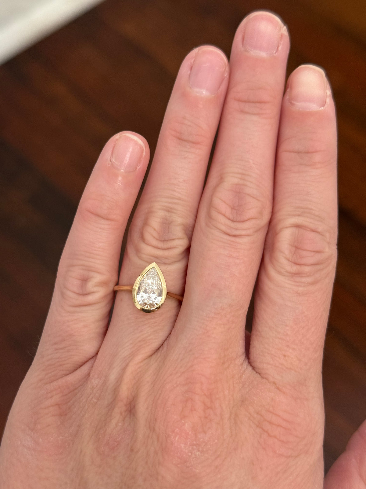 Yellow gold bezel set 1.96ct pear shaped lab diamond ring