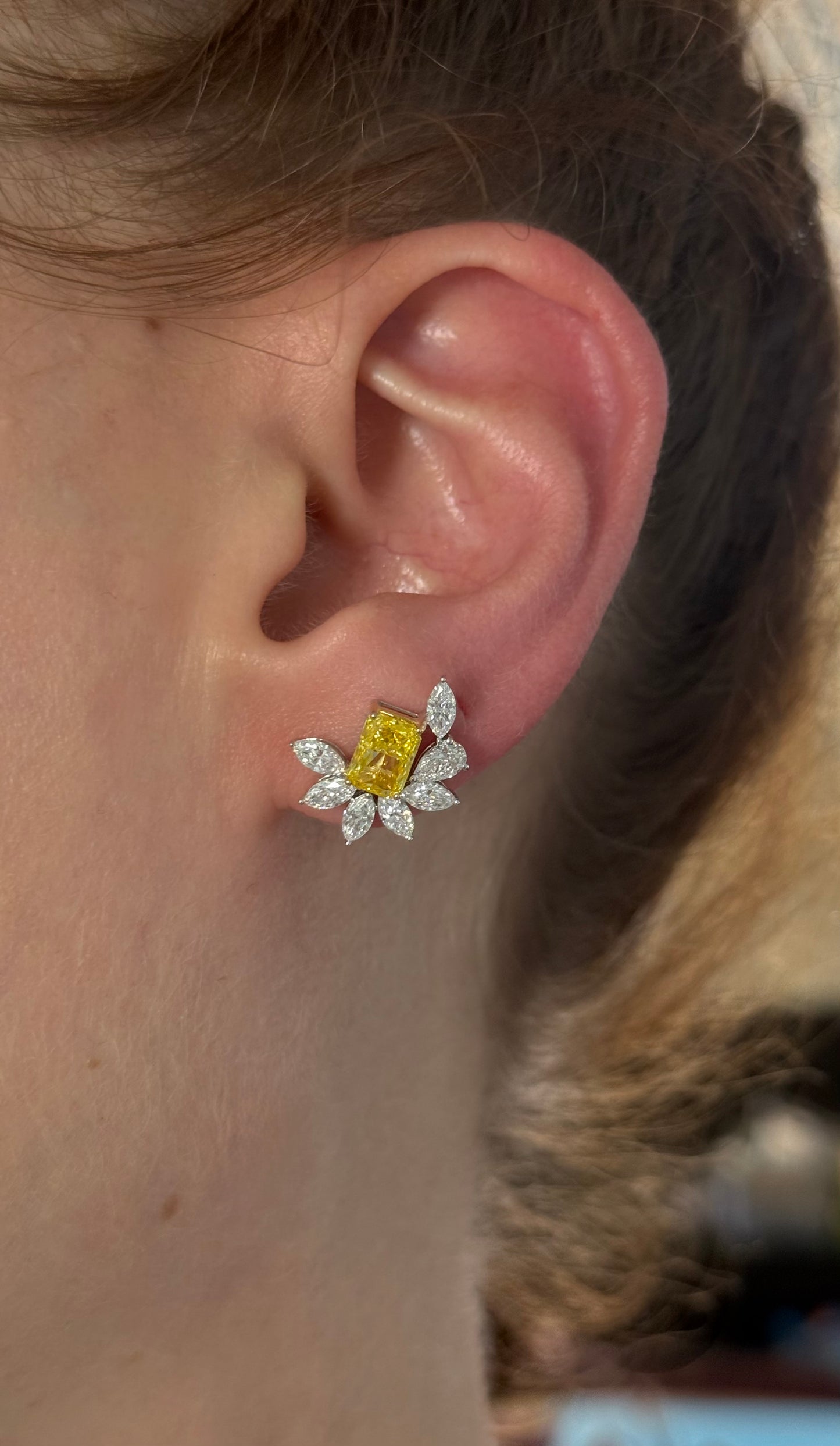 White gold radiant yellow lab diamond and pear shape and marquise white lab diamond earrings. Yellow lab diamond is set in yellow gold.