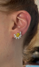 White gold radiant yellow lab diamond and pear shape and marquise white lab diamond earrings. Yellow lab diamond is set in yellow gold.