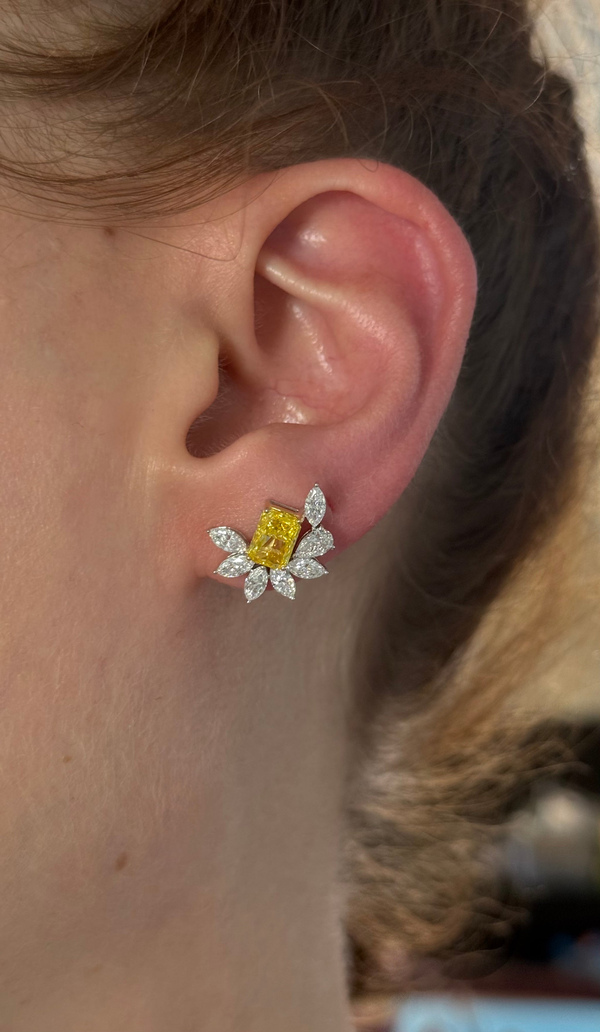 White gold radiant yellow lab diamond and pear shape and marquise white lab diamond earrings. Yellow lab diamond is set in yellow gold.