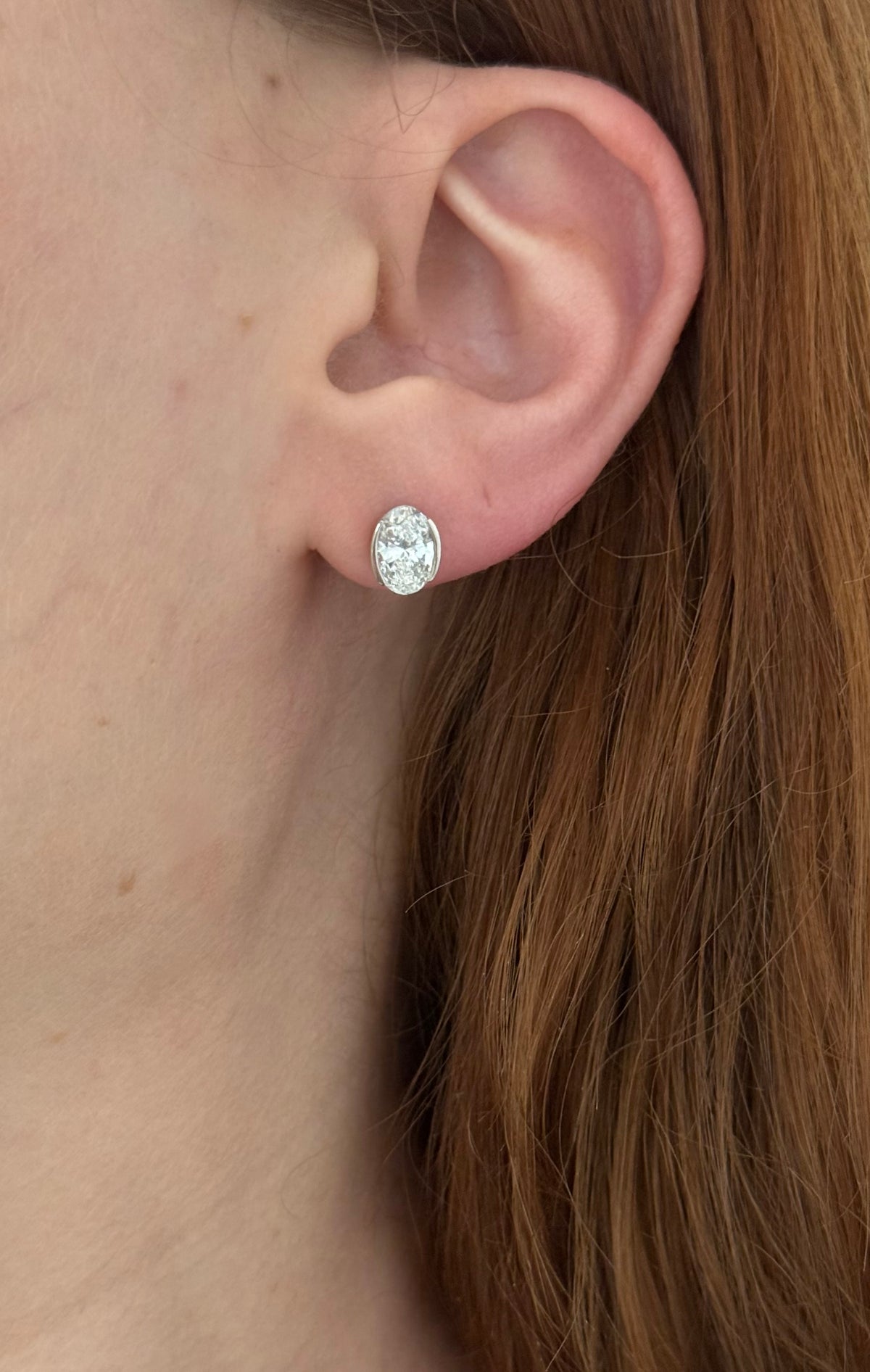 White gold bezel set oval lab diamond stud earrings