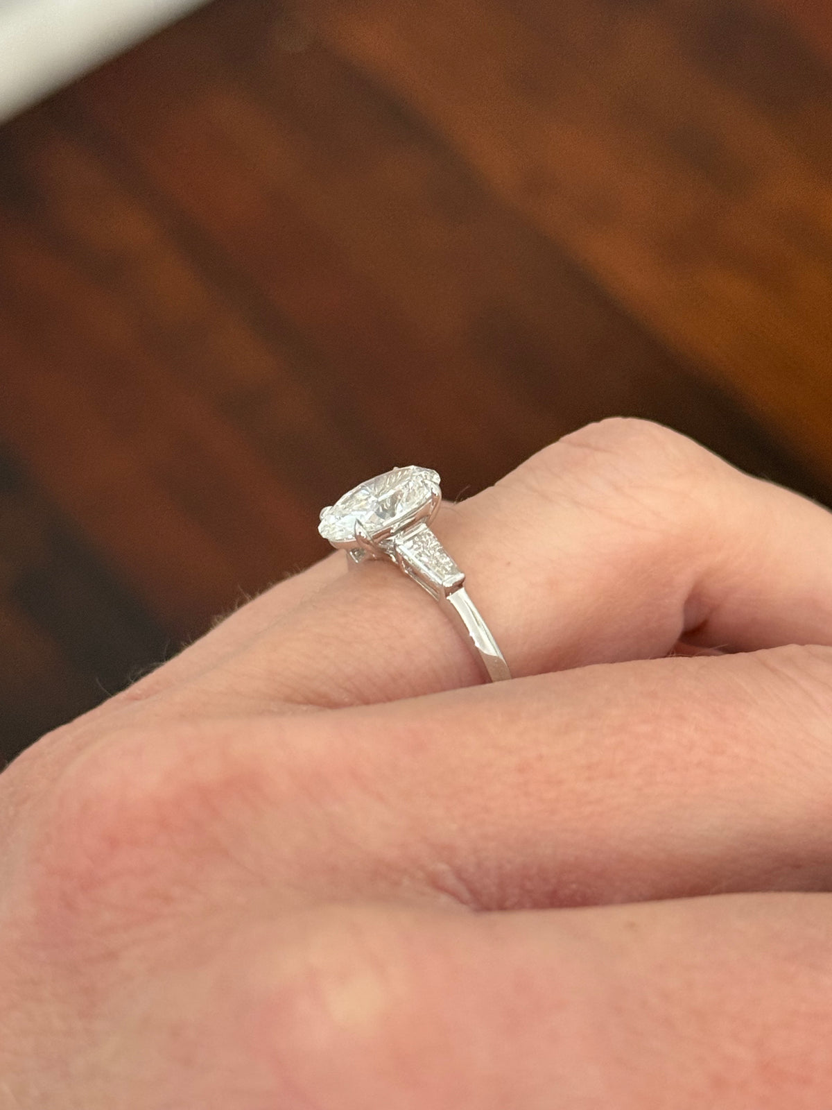 White gold IGI certified 2.02ct oval lab diamond and tapered baguette lab diamond ring. Oval measures 10.31x7.04x4.34mm
