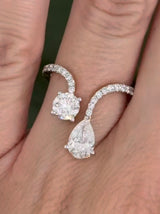 Yellow gold pear shape and round lab diamond ring. Prongs are white gold.